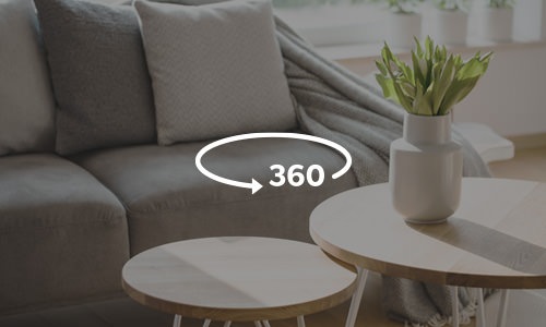 Picture of a living room couch and coffee table with a 360 icon to indicate there are virtual tours available